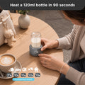 Universal Portable Bottle Warmer V3 - Portable bottle warmer heating a 120ml baby bottle on a café table, with five temperature options from 37°C to 70°C shown below.