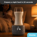Portable bottle warmer V3 preparing a bottle at 37°C on a bedside table, with a mother holding her baby in the background during a nighttime feed.
