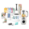 A baby feeding and storage set displayed on white stands against a light gray studio background. The set includes a white baby blender jar filled with colorful food, a white bottle, a black and white organizer insert, several pastel storage cups and spoons, a small pouch, two cleaning brushes, a package of cloth wipes, and a package of baby teethers.