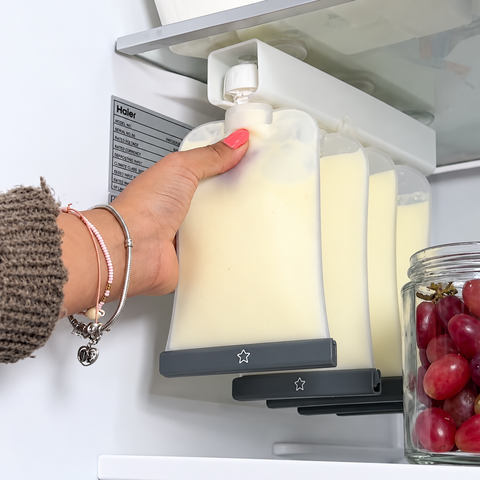 Reusable silicone breast milk and food pouches being stored in a pouch organiser in the fridge